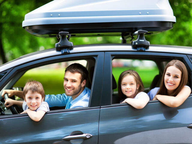 Happy family sitting in the car